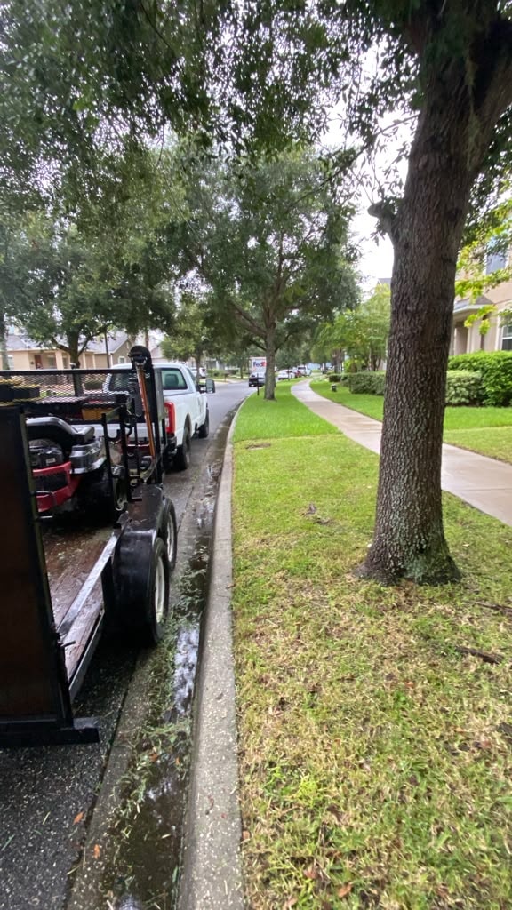 Bio-Cleaning Services truck and trailer on-site for landscaping and grounds maintenance — Central Florida.