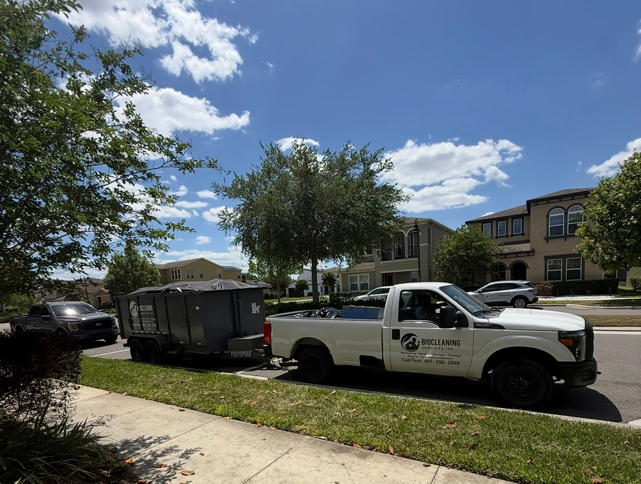 Bio-Cleaning Services truck and trailer used for property cleanouts and debris removal.
