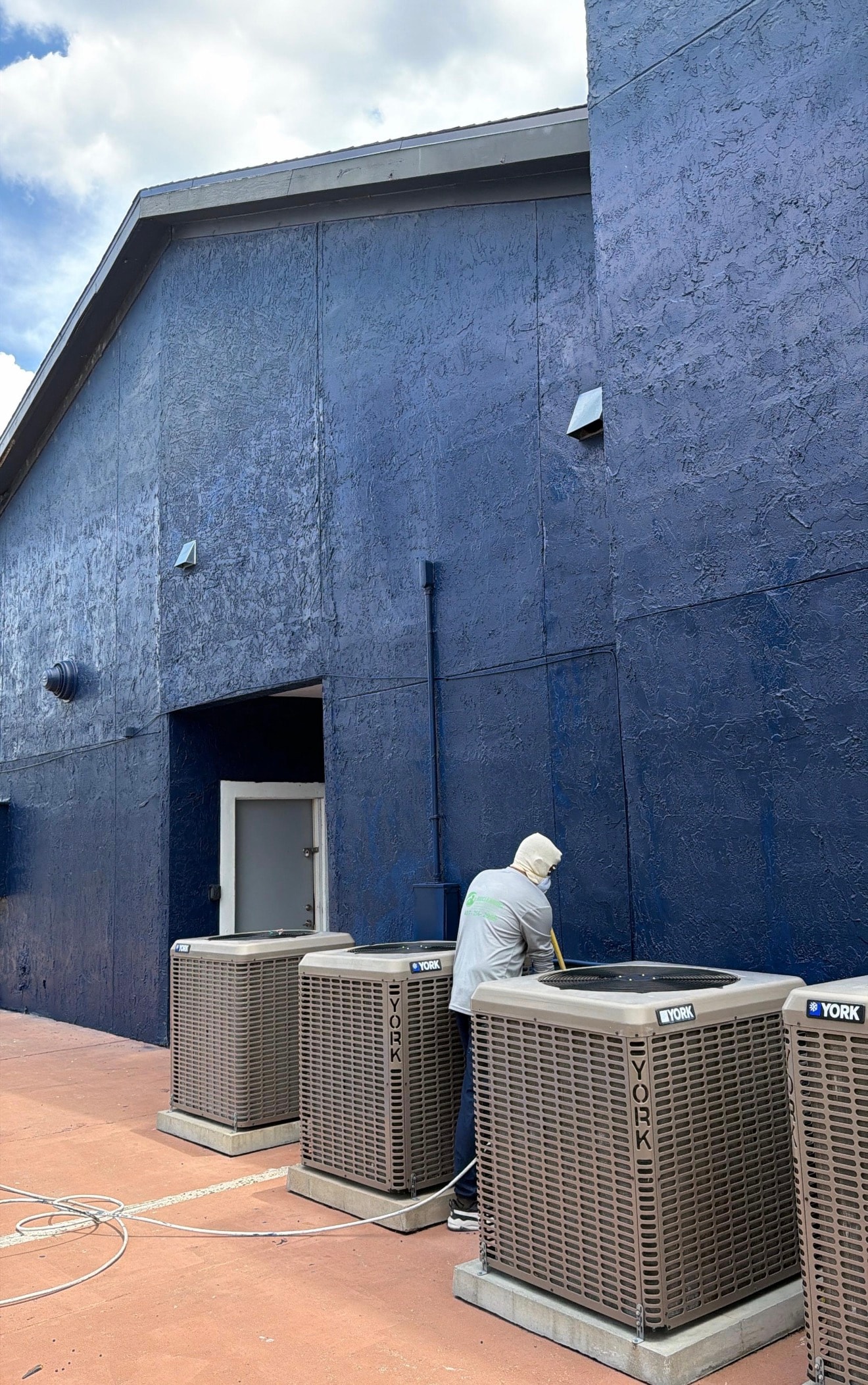 Bio-Cleaning Services technician performing exterior property repairs and handyman work.